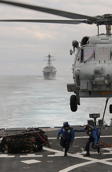 File:Defense.gov News Photo 111129-N-XQ375-322 - Seaman Lucio Robles left and Seaman Daniel Nogal clear the flight deck of the guided-missile destroyer USS Mitscher DDG 57 after attaching a cargo.jpg