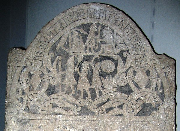 A detail from Gotland runestone G 181, in the Swedish Museum of National Antiquities in Stockholm. The three men are interpreted as Odin, Thor, and Freyr.