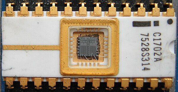 The first EPROM, an Intel 1702, with the die and wire bonds clearly visible through the erase window.