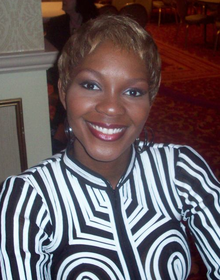 Miss America 2004 Ericka Dunlap signing autographs at a Miss America 2008 pageant event in January 2008 Ericka Dunlap 2008.png