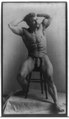Eugen Sandow, full-length portrait, seated on stool facing right, hands behind head, wearing fig leaf LCCN91789152.tif