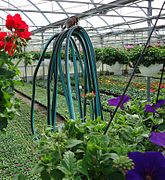 This greenhouse is equipped with a hose suspended on pulleys