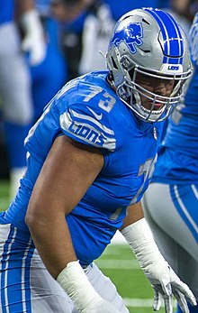 Jonah Jackson from the side, from about the thighs up, wearing his Detroit Lions uniform.