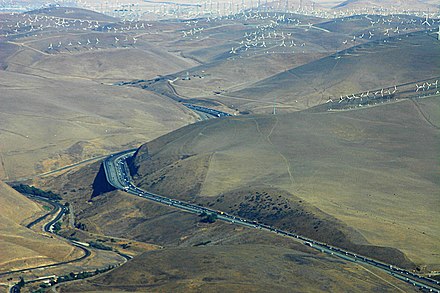 Wind turbines dot the landscape as Interstate 580 passes through the Altamont Pass Wind Farm Kluft-Photo-Aerial-I580-Altamont-Pass-Img 0037.jpg