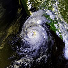 Satellite image of a tropical cyclone in the northeast Pacific Ocean. The hurricane has a ragged eye.