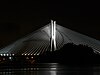 The Rędziński Bridge illuminated at night.