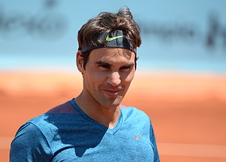 A tennis player holds a racket in his hand