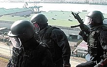 SAT operators preparing to rush out of their helicopter.jpg