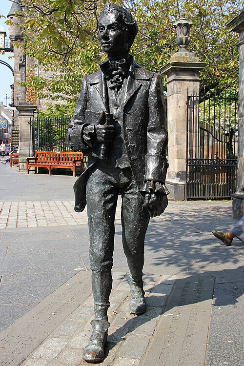 Bronze figure by David Annand of Robert Fergusson outside Edinburgh's Canongate Kirk where the poet is buried.