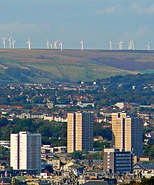 View over Halifax with the South Pennines in the background Towers and turbines (2938515319).jpg