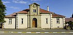 Single storey plastered brick building under hipped corrugated iron roof. Front elevation provided with sandstone gable and double timber door with arched fanlight. Steel windows. The cornerstone of the building was laid on 27 August 1926 by B Tromp (sen.) It was officially opened i (rest of text not in report. Does 'sen' mean Senator??) Type of site: Town Hall Current use: Town Hall. The building, which was erected in 1926/1927, forms part of the history of Trompsburg.