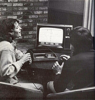 Two people playing a Fairchild Channel F