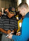 Woods signs autographs for the crew after a golf ball driving demonstration aboard the nuclear powered aircraft carrier USS George Washington (3 March 2004)