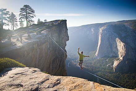 Man highlining at Taft Point in Yosemite National Park with El Capitan in the background.
