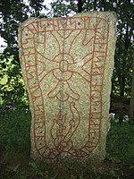 Rune stone, Sweden. With traditional gärdesgård fence in the