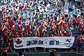 Canadian athletes in the closing ceremony with a banner that says "Thank you, Taipei" in Chinese.