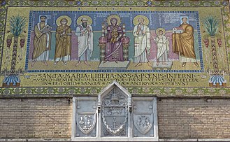 Mosaic on facade; it depicts Pope Zachary, Saint Julitta, Saint Paul, Mary and Jesus, Saint Peter, Saint Cyricus and the emperor Theodosius I. This image reproduces frescos from the Cappella di Teodoto, of Santa Maria Antiqua. 20 - s M Liberatrice mosaici e stemmi - part re P1040942.jpg