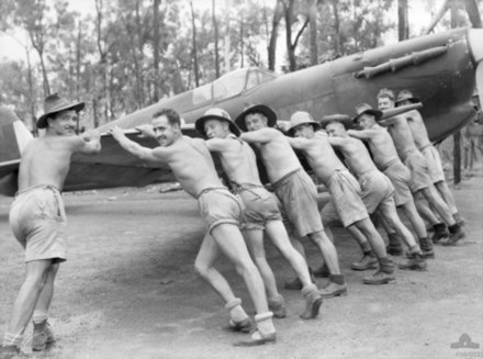 No. 457 Squadron ground crew push a Spitfire into its dispersal bay at Livingstone Airfield during February 1943