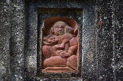 A breastfeeding mother depicted on a terracotta relief of a temple at Lowa.