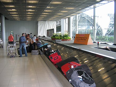 Collecting offloaded passenger luggage from a baggage carousel at Suvarnabhumi International Airport Bangkok, Thailand (2007)
