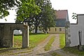 Residential stable house (No. 7), side building (No. 7a) and courtyard wall with gate to a three-sided courtyard