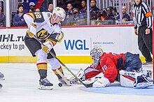 Holden making a play on the puck in front of Braden Holtby of the Washington Capitals in 2018. Braden Holtby save (50121732032).jpg