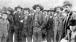 Cherokee Bill Goldsby posing with his captors during a stop by train to Nowata, 1895. Left to right are #5)Zeke Crittenden; #4)Dick Crittenden;Cherokee Bill; #2)Clint Scales, #1) Ike Rogers; #3) Deputy Marshall Bill Smith. Cherokeebill posing with captors.jpg