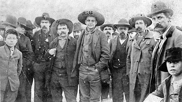 Cherokee Bill Goldsby posing with his captors during a stop by train to Nowata, 1895. Left to right are #5)Zeke Crittenden; #4)Dick Crittenden;Cheroke