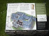 Panel turístico que muestra una posible reconstrucción de una abadía medieval.