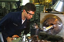 Turning a bar of metal on a lathe. Dreher an einer Drehbank.jpg