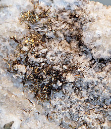 Natural electrum "wires" on quartz, historic specimen from the old Smuggler-Union Mine, Telluride, Colorado, USA Electrum on quartz Telluride (cropped).jpg