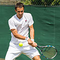 Evgeny Donskoy competing in the second round of the 2015 Wimbledon Qualifying Tournament at the Bank of England Sports Grounds in Roehampton, England. The winners of three rounds of competition qualify for the main draw of Wimbledon the following week.