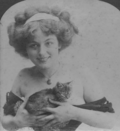 A woman with bare shoulders, holding a cat