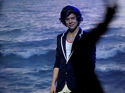 Harry Styles standing on stage during One Direction's Up All Night Tour in 2012