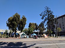 A tent city in Oakland, June 2018 Homeless encampment in Oakland near I-980.jpg