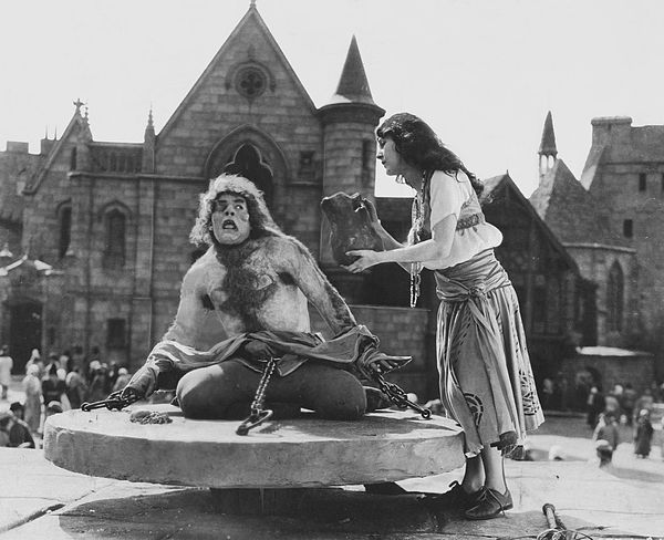 Quasimodo being offered water by Esmeralda.