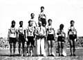 India cyclists at 1951 Asian Games – cycling team pursuit silver medallists Raj Kumar Mehra (standing on podium); Gurdev Singh, Dhangar (Lhanguard), Madan Mohan (standing left to right); and manager Bhoot (standing, fourth from left in blazer)