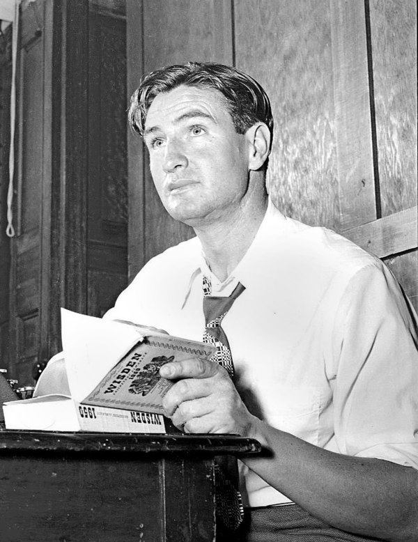 Miller reading Wisden Cricketers' Almanack in 1951