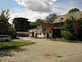 Residential mill house, barn, in between archway, production building and another five outbuildings of a mill property (forest mill)