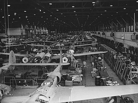 P-38 Lightning assembly line at the Lockheed plant, Burbank, California in World War II. In June 1943, this assembly line was reconfigured into a mechanized line, which more than doubled the rate of production. The transition to the new system was accomplished in only eight days. During this time production never stopped. It was continued outdoors.[13]