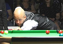 Reigning World Champion Luca Brecel (pictured) lost 2-5 in qualifying to 100th seed Ishpreet Singh Chadha. Luca Brecel EuM 2022-3.jpg