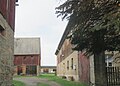 Residential stable house with a back bakery and two side buildings of a four-sided courtyard as well as remains of the paving