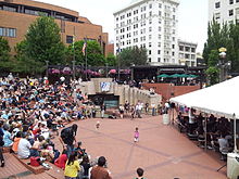 Hattner conducting the orchestra at Pioneer Courthouse Square in 2014 PYP performing at PCS (2014) - 1.jpg