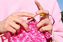 Pink knitting in front of pink sweatshirt