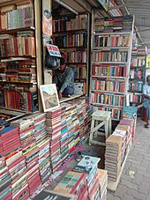 Roadside book stall and bookseller, College Street, Kolkata, India. Roadside book stall and bookseller at College Street, in Kolkata, West Bengal, India, photographed by Yogabrata Chakraborty, on June 8, 2022.jpg