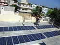 Rooftop solar array at Kuppam i-community office (54928934).jpg