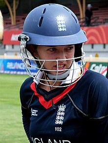 A head and shoulders picture of a cricketer wearing a batting helmet