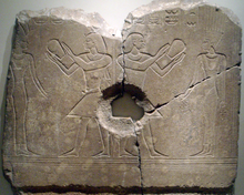 Sobekhotep III worshipping Satet. The central hole was made when the relief was used as a grinding stone, long after the original carving. Now on display at the Brooklyn Museum.