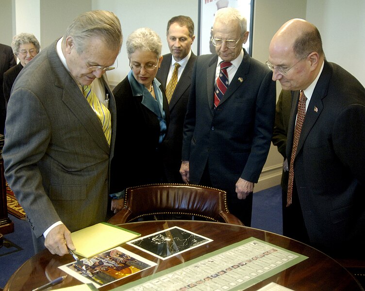 File:US Navy 060221-N-0696M-016 Secretary of Defense (SECDEF), the Honorable Donald H. Rumsfeld, left, and Secretary of the Navy (SECNAV), the Honorable Dr. Donald C. Winter, right, look at several artifacts in Rumsfeld's offi.jpg