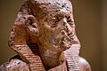 Upper part of portrait statue of pharaoh Amenemhat III wearing the nemes